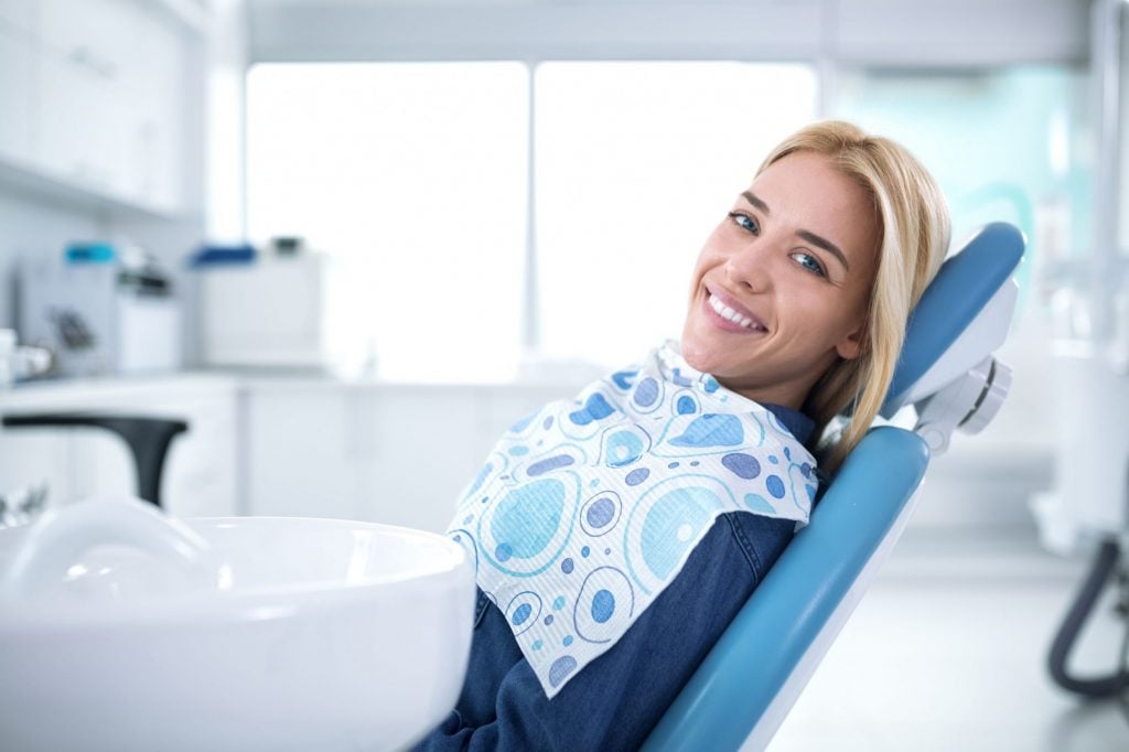 a smiling blonde female dental patient