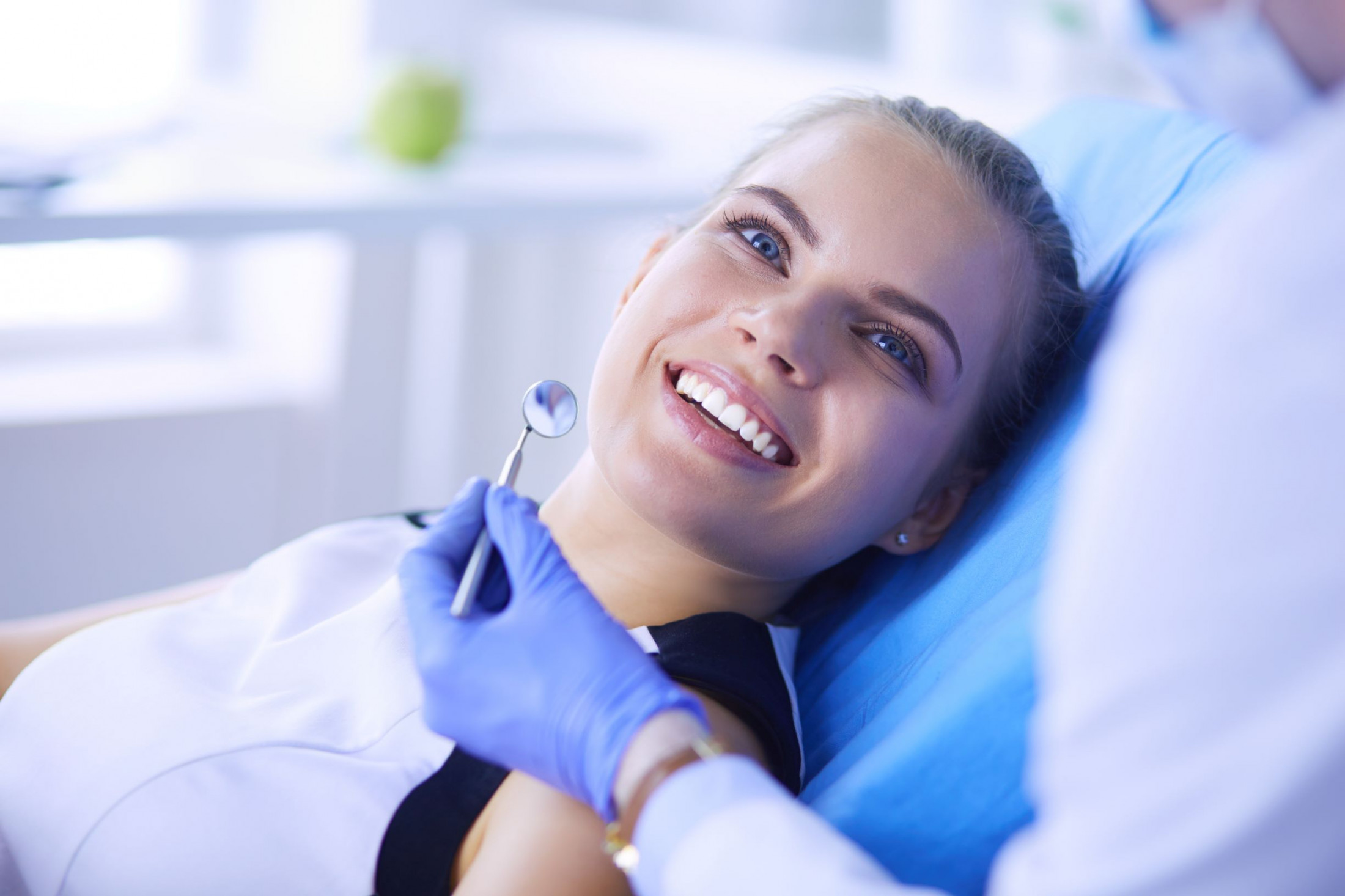 a woman smiling in a dental chair