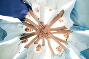 many dentists putting their hands together