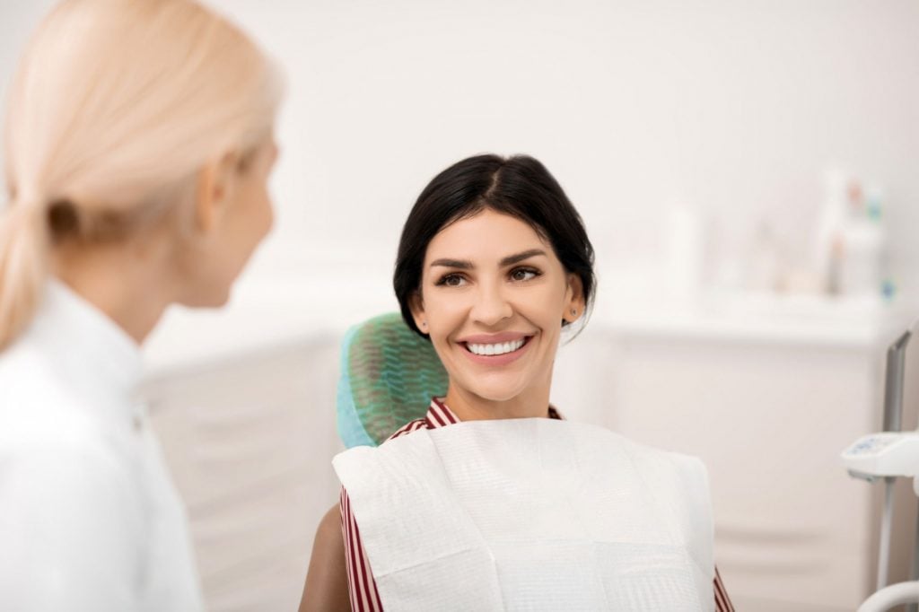 a smiling dental patient with perfect teeth